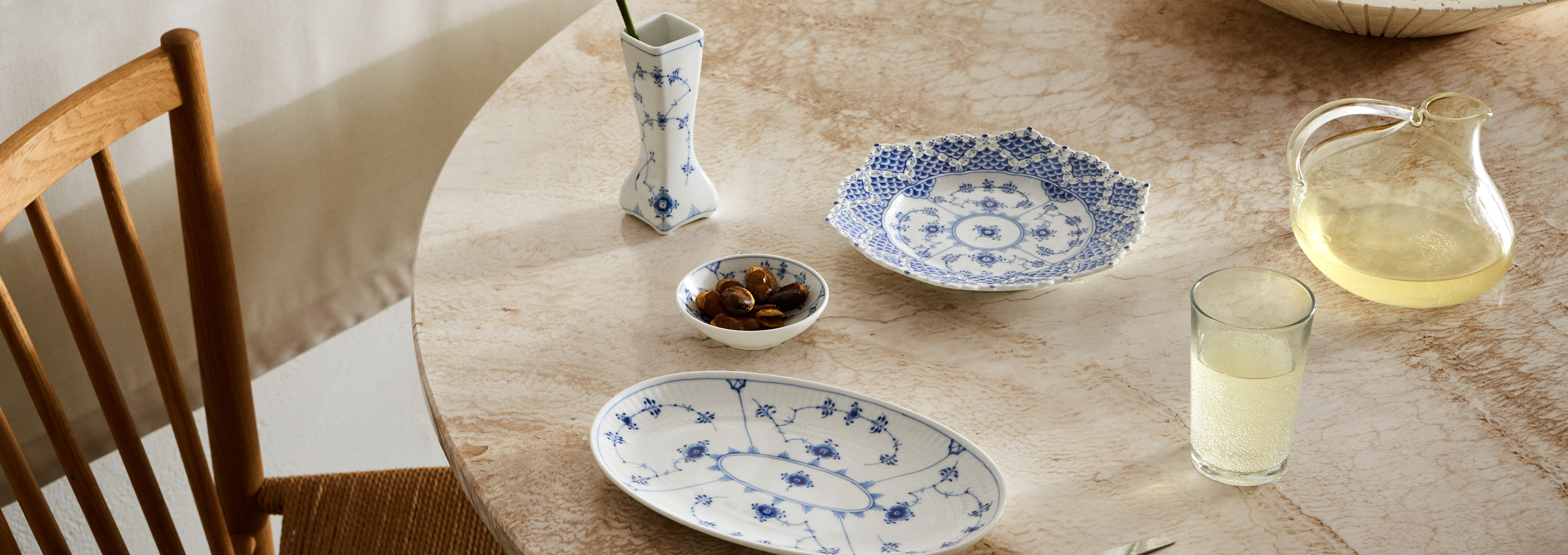A beautiful marble table set for one with the handpainted Blue Fluted Plain and Blue Fluted Full Lace dinner ware